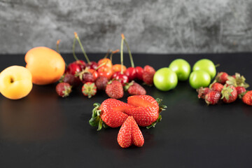 Summer fruit mixture on the black background