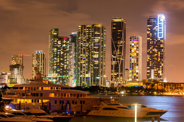 Fototapeta na wymiar Miami south beach street view with water reflections at night. Miami night downtown, city Florida.
