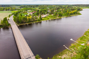 Fototapeta premium Aerial panoramic view of bridge in city Inkeroinen at river Kymijoki, Finland.