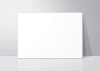 グレーの壁に立てかけたシンプルな白いボード - obrazy, fototapety, plakaty