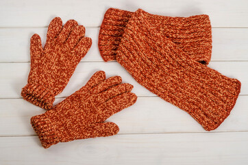 Terracotta knitted scarf and gloves. Winter clothes