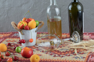 A summer fruit container with bottle of drink