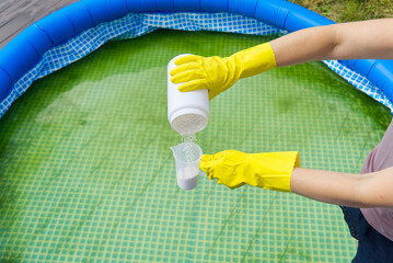 addition of chlorine powder for the pool to remove algae and disinfect water. inflatable swimming...