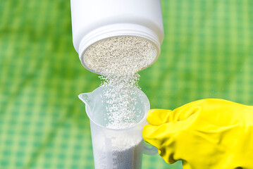 addition of chlorine powder for the pool to remove algae and disinfect water. inflatable swimming...