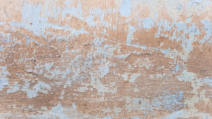 Old shabby wall with peeling plaster. Cracked stucco texture.