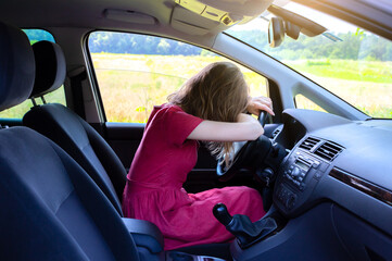 Woman in red dress is holding head on the wheel. Tired from problems. Dangerous situation on the road. Sleepy person. Broken car.