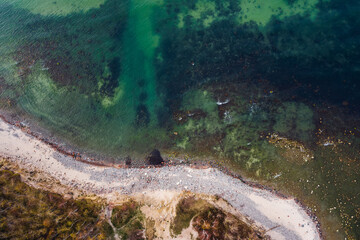 Rocky seashore and white sand, coast, top view. Tropical island. Aerial view.