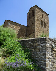 Fototapeta na wymiar View of the Bell tower of the Romanesque Church of San Andres in the village of Satue in the Serrablo Region. 11th century. Aragon. Spain.
