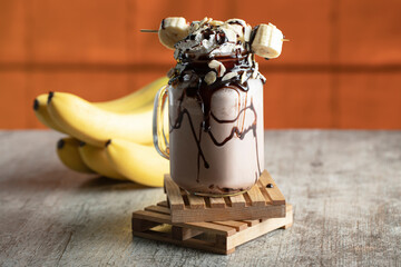 Fototapeta na wymiar milky cocktail with banana and chocolate syrup