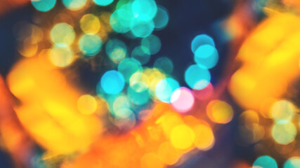 Colorful background with natural bokeh texture and defocused sparkling lights. Teal and orange blur with background with twinkling lights. Festive lights overlay with copy space