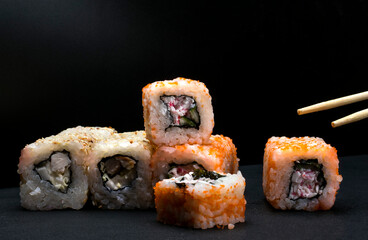 rice rolls with crab meat on a black background