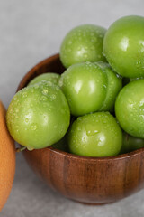 Cherry plums in the bowl with water drops on them