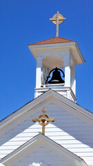 Church steeple and bell tower with crosses.