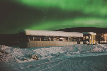 Northern Lights over abandoned train car in Alaska
