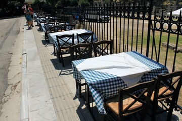 Greece, Athens, July 16 2020 - Empty chairs and tables of a traditional restaurant in the touristic district of Plaka. 