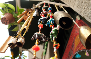 Bells, beads, paper elephants and wind chimes - symbols and signs of indian (hindu) and buddhist religions and tradition, low angle perspective. - obrazy, fototapety, plakaty