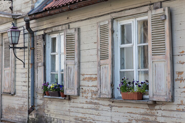 Fototapeta na wymiar the old house has two shuttered windows 