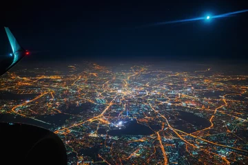 Zelfklevend Fotobehang Aerial view to night city from the plane. Moon in the sky © Ivan Kurmyshov