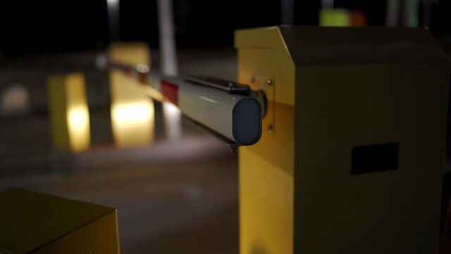 Car auto parking at the airport terminal security system boom barrier gate at night