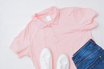 Flat lay female fashion look with stylish clothes and accessories on a light background