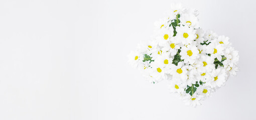 Flat lay composition with a bouquet of white flowers on a white background