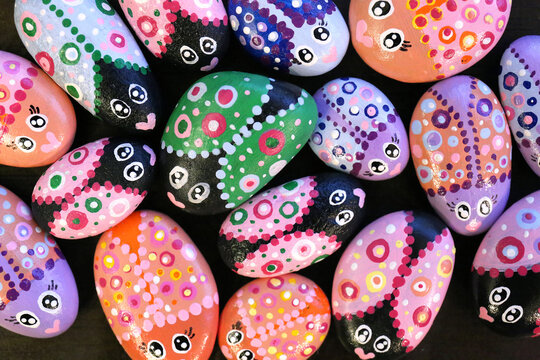 Painted Kindness Rocks Decorated like Colorful Bugs in a Design