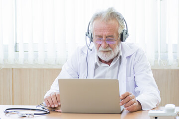 Senior doctor giving advise to a patient via phone