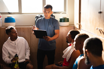 Multi ethnic group of male football in changing room