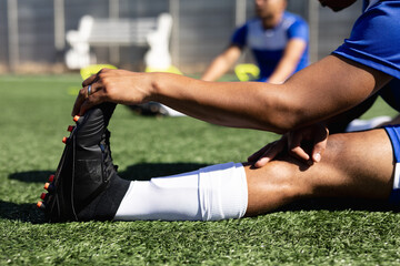 Mixed race male football player training at a sports field