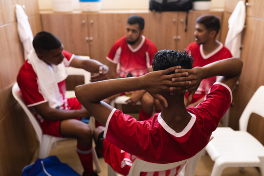 Multi ethnic group of male football in changing room