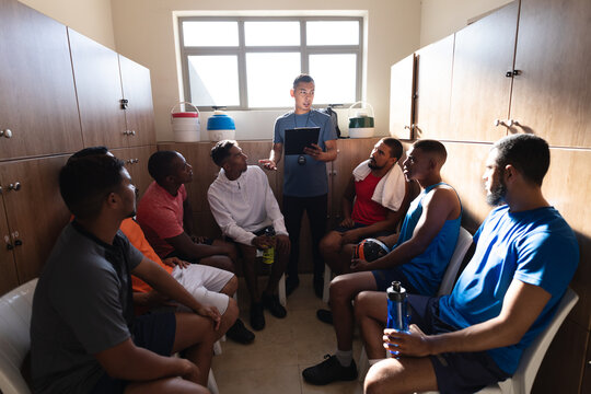Multi ethnic group of male football in changing room