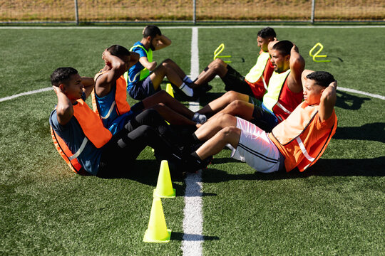 Multi ethnic team of male football players training at a sports field
