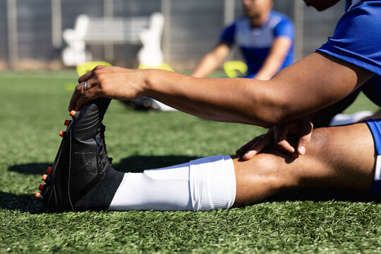 Mixed race male football player training at a sports field - Powered by Adobe