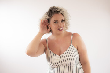 Fototapeta premium Blonde young woman making listening gesture