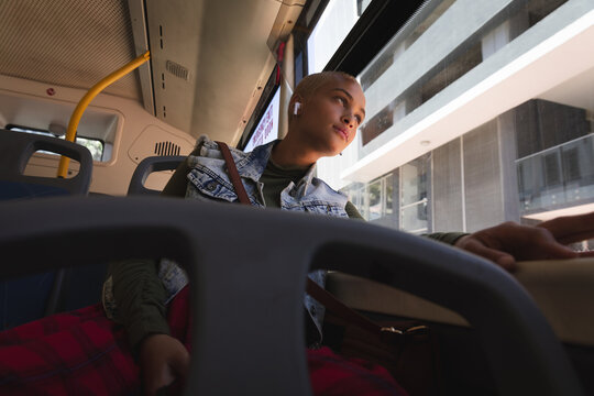 Mixed race alternative woman sitting in a bus