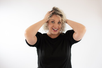 Fototapeta premium Blonde young woman smiling with surprise gesture