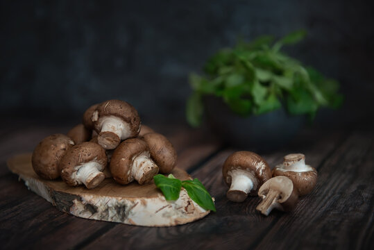 Royal mushrooms on a wooden table and planks of birch log. Image with selective focus