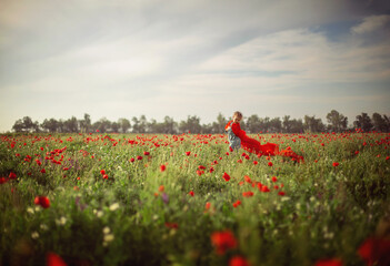 
a girl walking in a poppy field