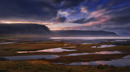 West Fjords or The Westfjords is region in north Iceland. Dramatic moody sky nature landscape at sunset
