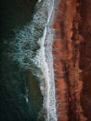 Raudisandur Beach with red sand, aerial view from drone, West Fjords or The Westfjords region in north Iceland. Nature landscape from above