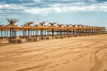 Empty sandy beach and rows resting places in the failed tourist season.
