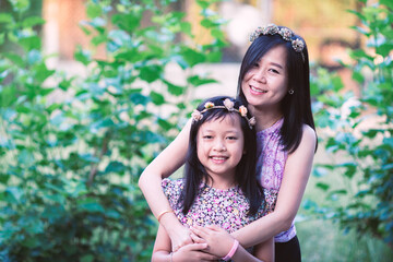 Fototapeta premium Asian Mom hugging her daughter with love.Mother day and family concept