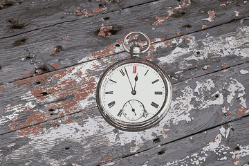 Antique Pocket Watch.  Before Midnight .Weathered wooden background. Room for message. Stock Image.