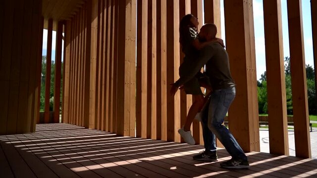 happy lovers are having fun, woman is jumping on her boyfriend, he is catching her