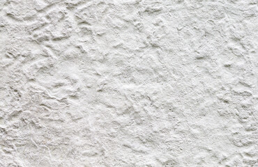White painted rough weathered concrete wall, close-up.