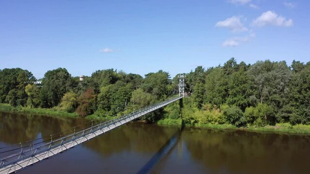 flight over suspension pedestrian bridge through the Neman river in the city Mosty, Republic of Belarus.