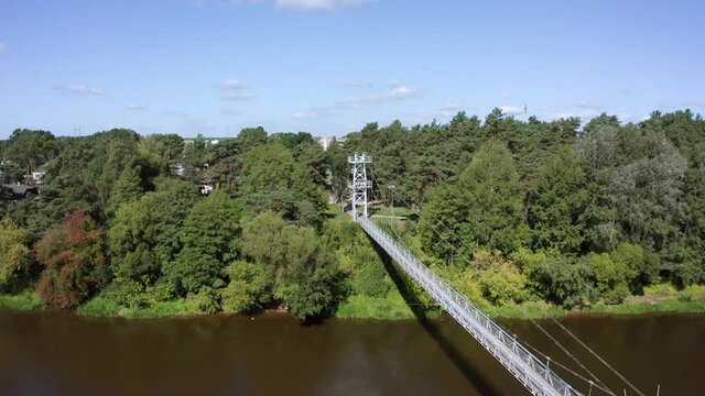 flight over suspension pedestrian bridge through the Neman river in the city Mosty, Republic of Belarus.