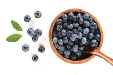 Blueberries in a wooden bowl with a spoon