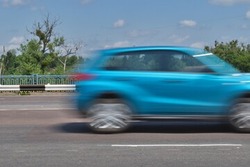 Fototapeta na wymiar motion blurred SUV at high speed on highway