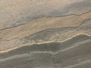 Tile on the wall, abstract texture, dark background. Background image of natural stone, close-up. The structure of ceramic tiles.